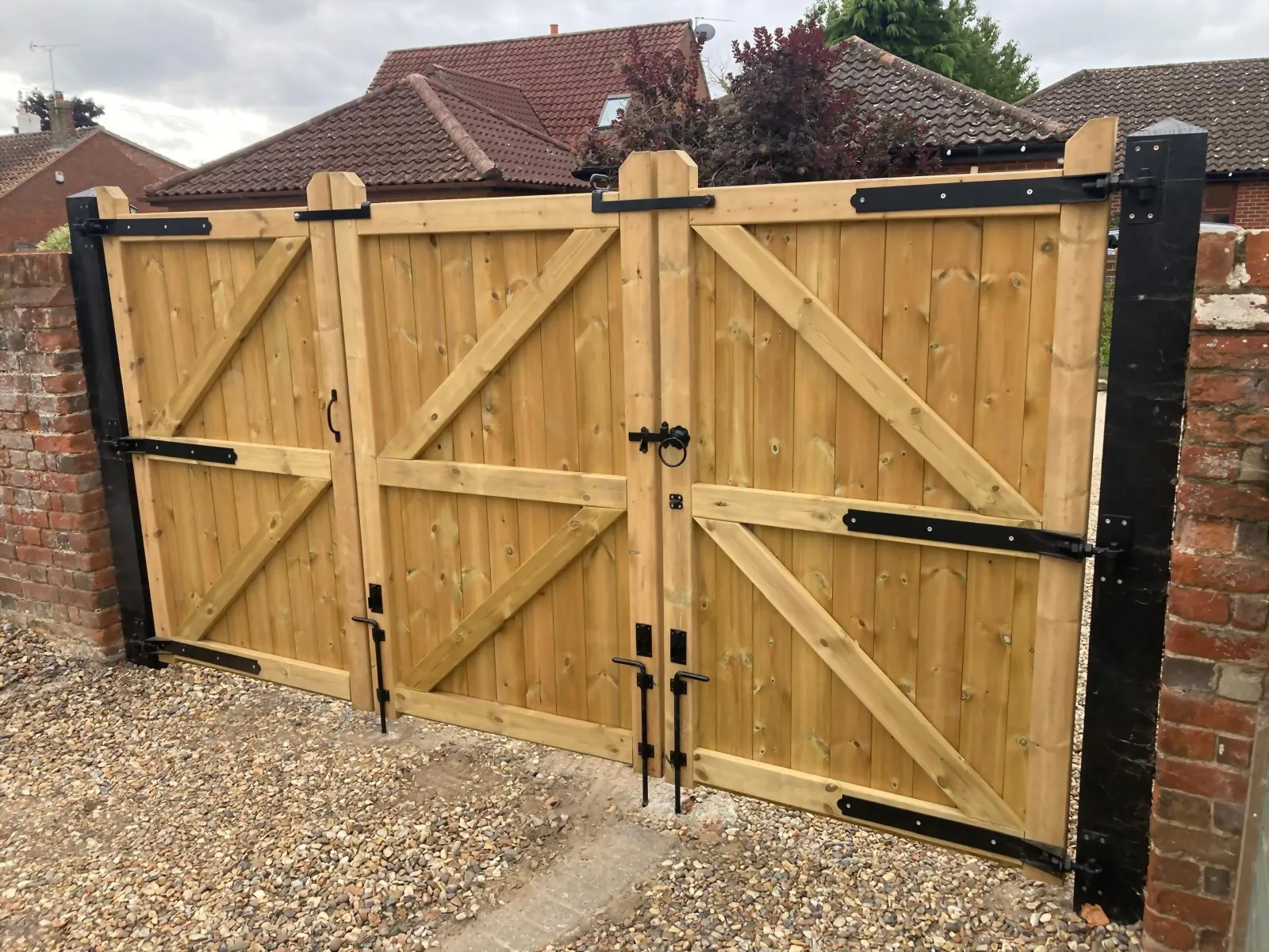 Hand-braced timber driveway gates built by Standfast Fencing